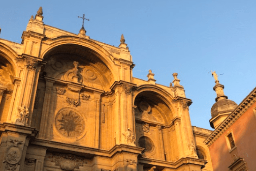 a church with a clock on the side of a building