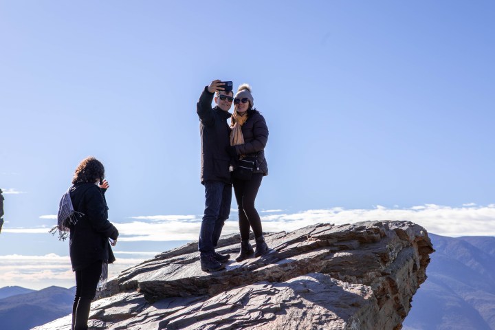 a person standing on a snow covered mountain