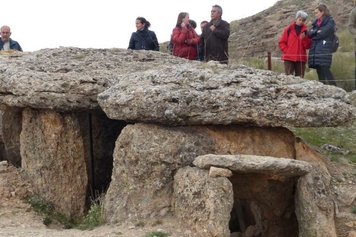 a group of people standing on a rock