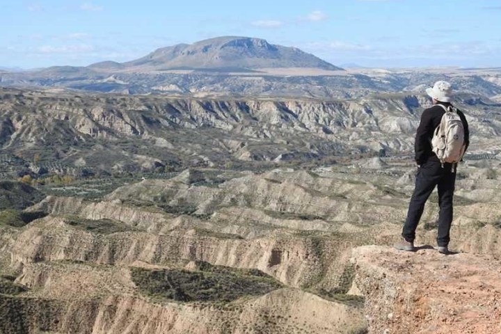 a man standing in front of a mountain