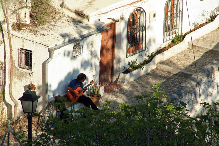 a man standing next to a waterfall