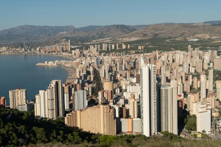 a large body of water with a city in the background