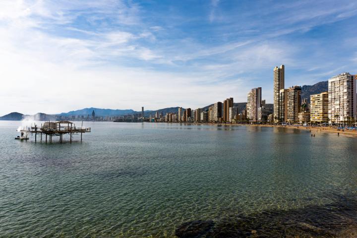 a body of water with a city in the background